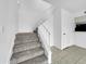 Carpeted staircase leading to upstairs area, blending seamlessly with the tile flooring at 4416 E Riverside St, Phoenix, AZ 85040