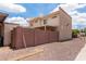 Tan two-story building featuring a covered patio and a sturdy red brick wall, complemented by a gravel-covered yard at 4515 N 26Th Dr, Phoenix, AZ 85017