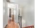 Upstairs hallway, showcasing wood floors and views into a bedroom at 4515 N 26Th Dr, Phoenix, AZ 85017
