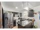 Modern kitchen with stainless steel appliances, dark cabinetry, and bright countertops at 4515 N 26Th Dr, Phoenix, AZ 85017