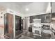 Updated kitchen with sleek appliances, dark cabinets, and seamless transitions to other spaces at 4515 N 26Th Dr, Phoenix, AZ 85017