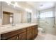 Bathroom featuring a double vanity sink, tiled floor, walk-in shower with glass block at 5249 E Shea Blvd # 215, Scottsdale, AZ 85254
