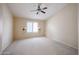 Spacious bedroom with neutral carpet, a window with shutters and a ceiling fan at 5249 E Shea Blvd # 215, Scottsdale, AZ 85254