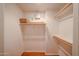 Walk-in closet with built-in shelves and clothes racks and hardwood floor at 5249 E Shea Blvd # 215, Scottsdale, AZ 85254