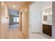 Hallway leading to the bathroom and bedroom with carpeted floors and neutral paint at 5249 E Shea Blvd # 215, Scottsdale, AZ 85254
