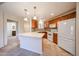 Bright eat-in kitchen with tile floors, central island, wood cabinets and modern appliances at 5249 E Shea Blvd # 215, Scottsdale, AZ 85254