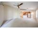 Spacious living room flowing into kitchen and featuring carpet and a ceiling fan at 5249 E Shea Blvd # 215, Scottsdale, AZ 85254