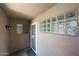 A private porch featuring a security door, glass block window and outdoor lantern at 5249 E Shea Blvd # 215, Scottsdale, AZ 85254