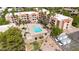Discover a refreshing pool area with covered seating, sun loungers, and garden spaces in this vibrant aerial perspective at 540 N May St # 1109, Mesa, AZ 85201