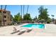 Enjoy relaxing by the community pool with lush landscaping and comfortable lounge chairs for poolside relaxation at 540 N May St # 1109, Mesa, AZ 85201