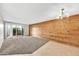 Bright and airy living room features wood paneled wall and a sliding glass door that offers access to the outdoor area at 540 N May St # 1109, Mesa, AZ 85201