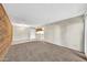Spacious living room with hardwood accent wall and tile floor transitioning to carpet, a comfortable and stylish living space at 540 N May St # 1109, Mesa, AZ 85201