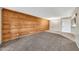Spacious living room featuring a wood paneled accent wall with tile floor transitioning to carpet, ideal for relaxing and entertaining at 540 N May St # 1109, Mesa, AZ 85201