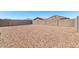 Large backyard featuring rock landscaping and a block privacy wall at 5626 W Rainwater Dr, Laveen, AZ 85339
