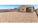 Large backyard with a rock landscape and block wall at 5626 W Rainwater Dr, Laveen, AZ 85339