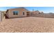 Spacious backyard featuring a rock landscape and privacy wall at 5626 W Rainwater Dr, Laveen, AZ 85339