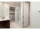 Clean bathroom featuring a glass shower, a toilet, tile flooring, and an entrance to a walk-in closet at 5626 W Rainwater Dr, Laveen, AZ 85339