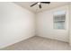 A bright bedroom features a ceiling fan and a window at 5626 W Rainwater Dr, Laveen, AZ 85339