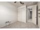 A carpeted bedroom showcases a ceiling fan, closet, and access to another room at 5626 W Rainwater Dr, Laveen, AZ 85339