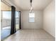 Open dining area featuring neutral tile flooring, a modern chandelier, and sliding glass doors at 5626 W Rainwater Dr, Laveen, AZ 85339