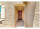 Inviting entryway featuring a classic wooden door and textured stucco walls at 5626 W Rainwater Dr, Laveen, AZ 85339