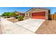 Charming single-story home featuring a two-car garage, low maintenance landscaping, and a classic stucco facade at 5626 W Rainwater Dr, Laveen, AZ 85339