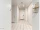 Bright hallway with neutral tile flooring, white walls, and built-in shelving at 5626 W Rainwater Dr, Laveen, AZ 85339