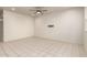 Bright living room featuring neutral tile floors, ceiling fan, and ample natural light at 5626 W Rainwater Dr, Laveen, AZ 85339