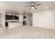 Open floor plan with tile flooring connecting the living, dining, and kitchen areas, creating a cohesive and inviting space at 5626 W Rainwater Dr, Laveen, AZ 85339