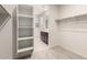 Spacious walk-in closet boasts built-in shelving and convenient access to the primary bathroom at 5626 W Rainwater Dr, Laveen, AZ 85339