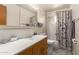 Functional bathroom featuring a combination tub/shower and a modern vanity at 62 W Beall Ave, Mesa, AZ 85210