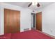 Bedroom with double closets, ceiling fan, and access to an ensuite bathroom at 62 W Beall Ave, Mesa, AZ 85210