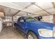 Garage featuring a blue Dodge Ram 1500 pickup truck and overhead storage at 62 W Beall Ave, Mesa, AZ 85210