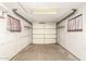 Empty garage with two shelves and an overhead light at 62 W Beall Ave, Mesa, AZ 85210