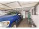 Garage featuring a blue Dodge Ram 1500 pickup truck and some yard tools at 62 W Beall Ave, Mesa, AZ 85210