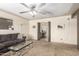 Comfortable living room with a view into the dining room, a ceiling fan, and a comfortable couch at 62 W Beall Ave, Mesa, AZ 85210