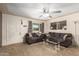 Comfortable living room with a ceiling fan, carpeted floors, and large windows for plenty of natural light at 62 W Beall Ave, Mesa, AZ 85210