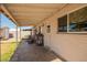 Covered outdoor patio with access door to the home and concrete flooring at 62 W Beall Ave, Mesa, AZ 85210