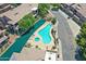 Aerial view of the community pool and spa surrounded by a scenic waterway at 705 W Queen Creek Rd # 1201, Chandler, AZ 85248