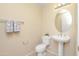 Powder room featuring a pedestal sink, a round mirror, and decorative towels at 705 W Queen Creek Rd # 1201, Chandler, AZ 85248