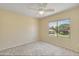 Carpeted bedroom with large windows showcasing the outdoors and a ceiling fan at 705 W Queen Creek Rd # 1201, Chandler, AZ 85248