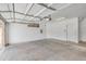 Empty garage featuring overhead door and hardware with white walls and concrete floor at 705 W Queen Creek Rd # 1201, Chandler, AZ 85248