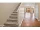 Inviting staircase leading to the upper level, with carpeting and views of the hallway at 705 W Queen Creek Rd # 1201, Chandler, AZ 85248