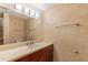 Bathroom featuring a marble vanity, lighted mirror and tile walls at 7167 E Rancho Vista Dr # 2007, Scottsdale, AZ 85251