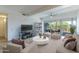 Bright living room with stylish furniture, large windows, and access to the outdoor patio at 7167 E Rancho Vista Dr # 2007, Scottsdale, AZ 85251