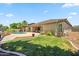Private backyard oasis with a sparkling pool, lush lawn, and covered patio, perfect for outdoor entertaining at 8417 W Northview Ave, Glendale, AZ 85305