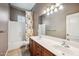 Bathroom with double sinks, white countertops, dark wood cabinets, and floral shower curtain at 8417 W Northview Ave, Glendale, AZ 85305