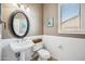 Powder bathroom with pedestal sink, decorative mirror, and white subway tile at 8417 W Northview Ave, Glendale, AZ 85305