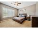 Serene bedroom with plantation shutters, a ceiling fan, and a modern wooden bed frame at 8417 W Northview Ave, Glendale, AZ 85305