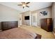 Well-appointed bedroom featuring a ceiling fan, a door to the outside, and ample dresser space at 8417 W Northview Ave, Glendale, AZ 85305